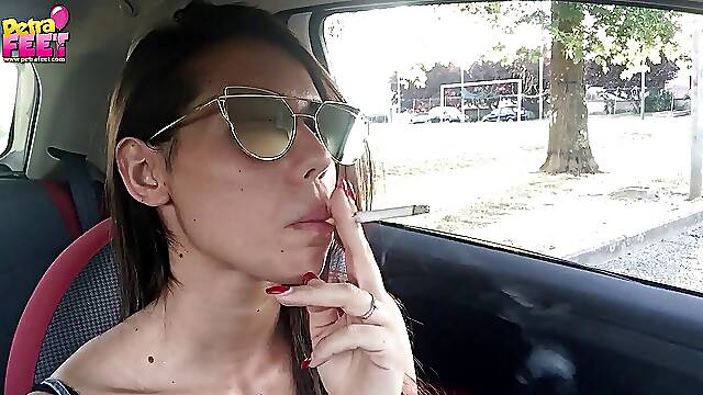 Cute teen Petra smoking in the car